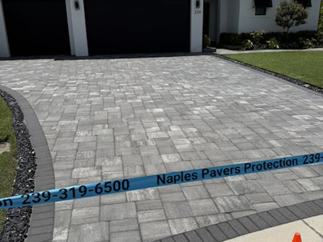 A sealed paver driveway in Naples with a charcoal border course