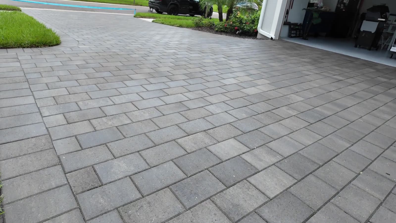 A charcoal paver driveway in Naples, cleaned and sealed