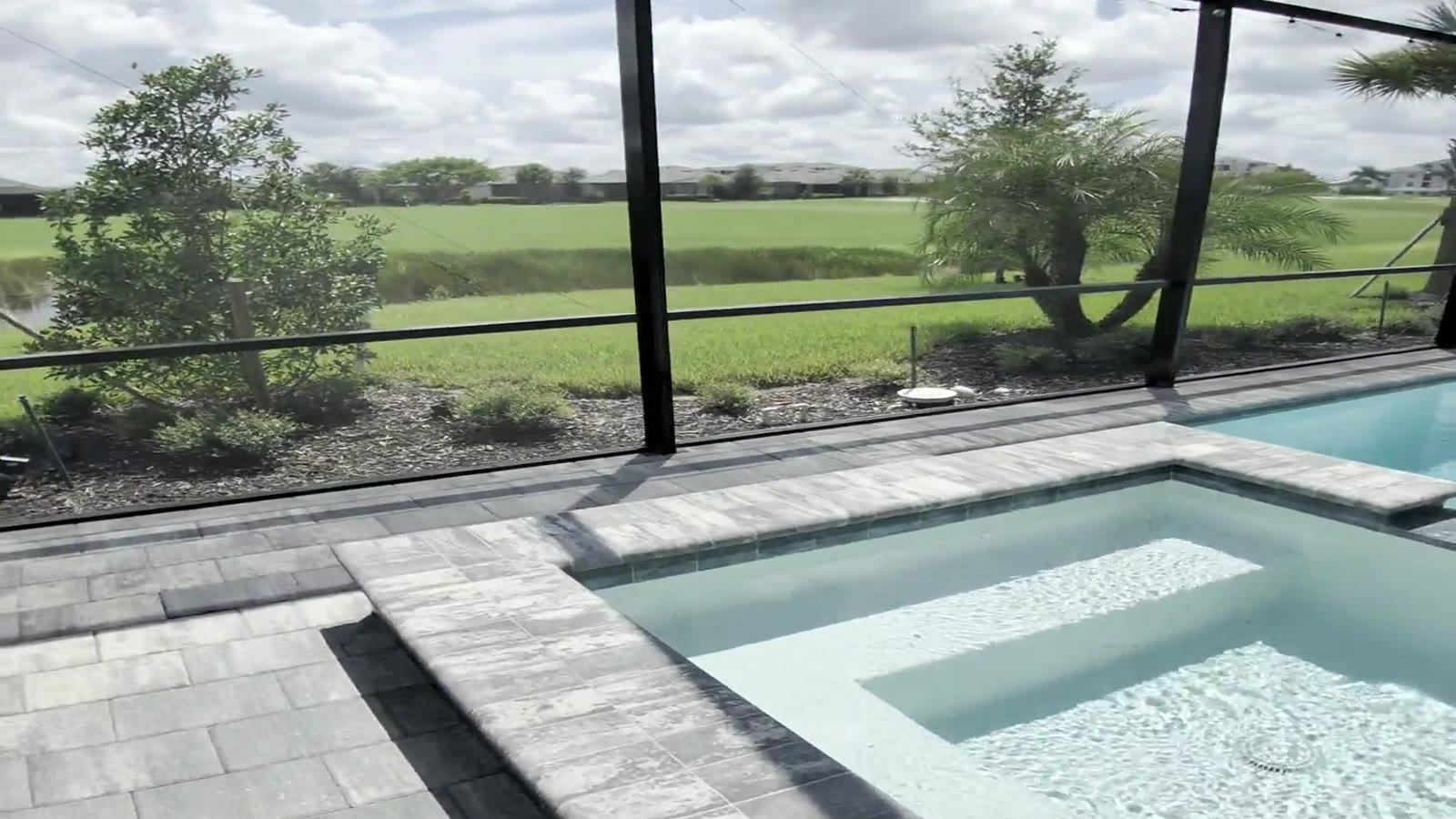 A screened lanai and pool deck in Naples, the kind of surface a soft wash is for