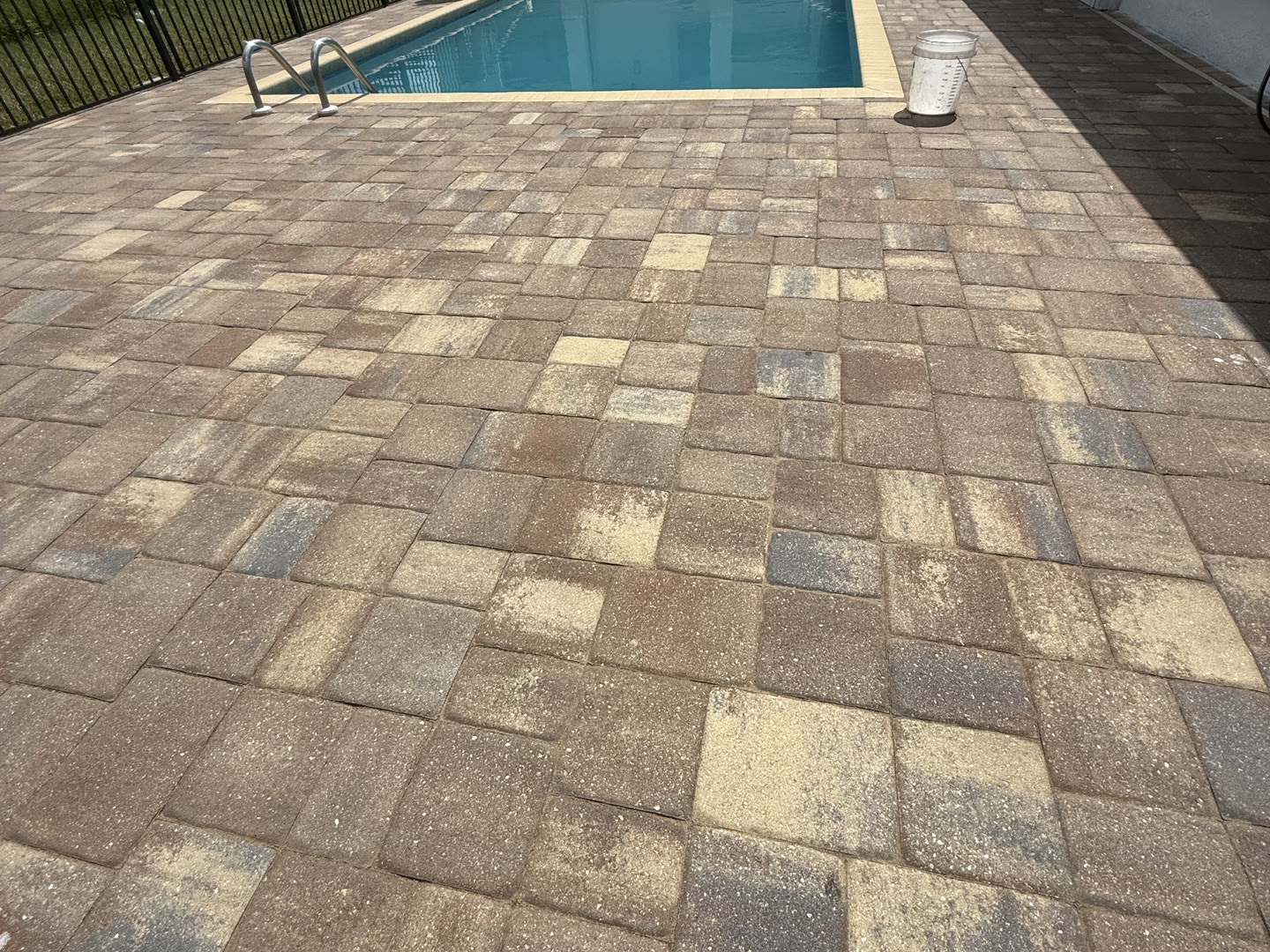 A paver pool deck and pool in Naples after cleaning and sealing