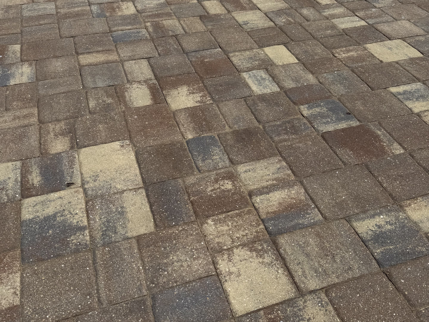 Warm toned pavers on a Naples pool deck, close up