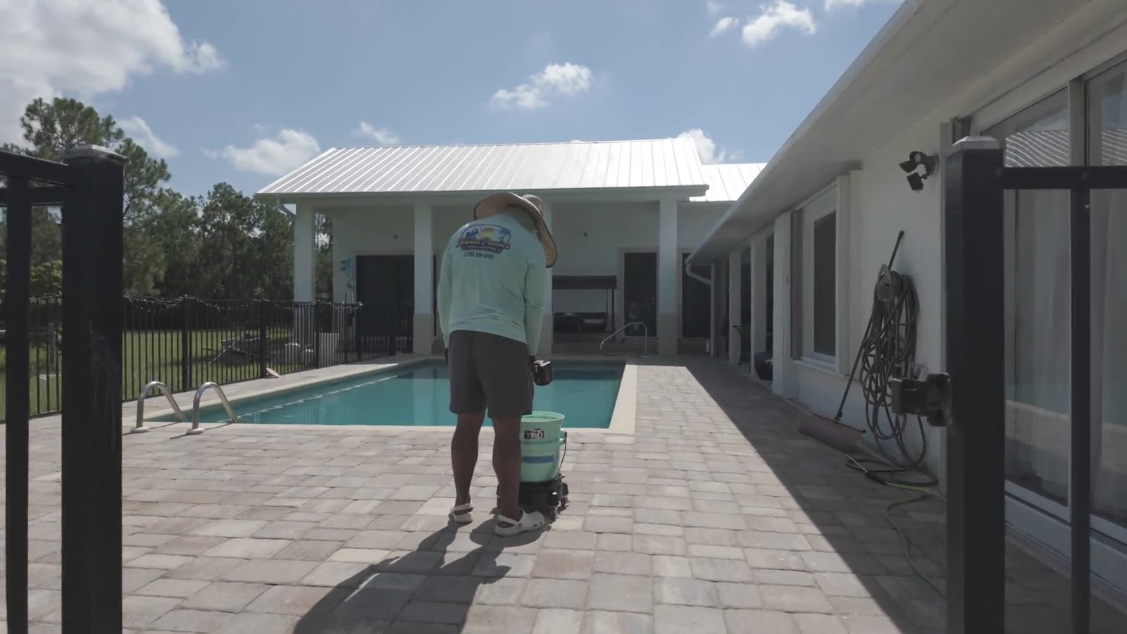 A travertine pool deck in Naples being washed down